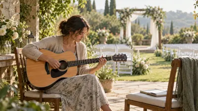 A musician practices with an acoustic guitar in a quiet garden venue the morning before a wedding, rows of empty white chairs and flowers in soft focus behind, a notebook resting on a chair beside them, in gentle morning light
