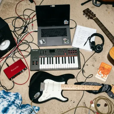 home studio with a computer, guitar, and audio interface