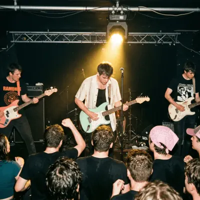 Rock band performing live for a crowd in a small music venue